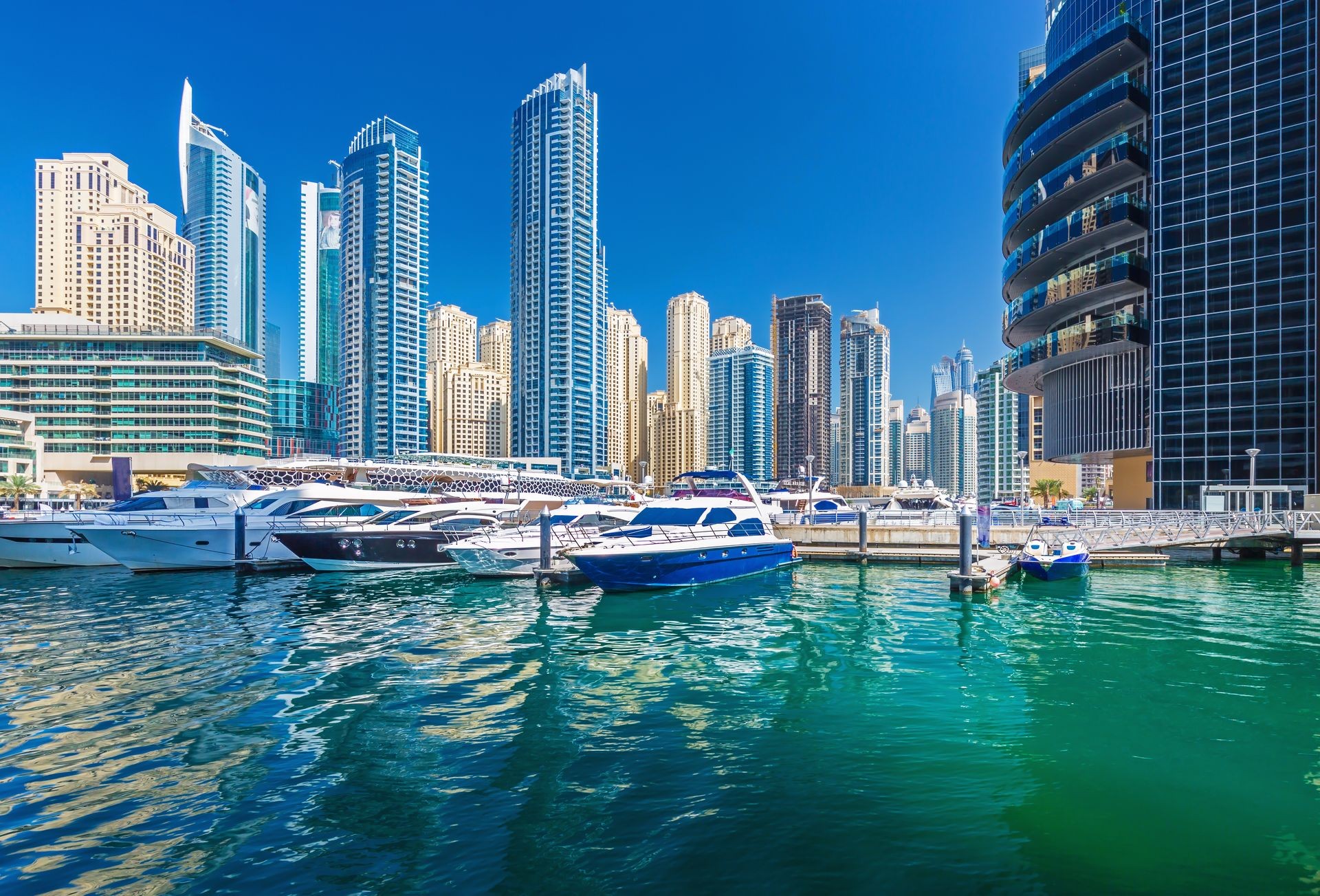 Dubai Marina with yachts, luxury skyscrapers and promenade, Dubai, United Arab Emirates Dubai Marina with yachts, luxury skyscrapers and promenade, Dubai, United Arab Emirates